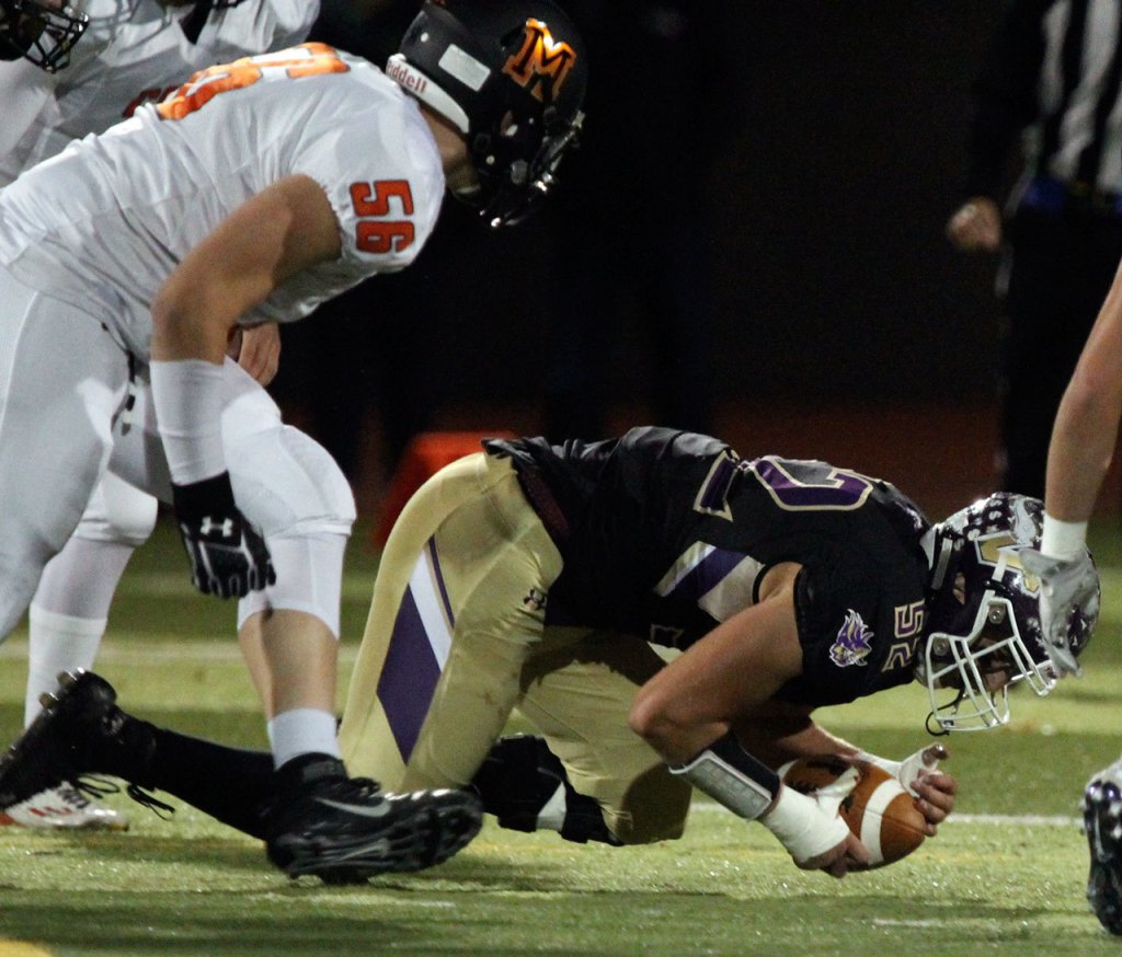 Lake Stevens&rsquo; Zack Kylany recovers a fumble with Monroe&rsquo;s Peyton McMahon trailing during a game Friday at Lake Stevens High School. (Kevin Clark / The Herald)