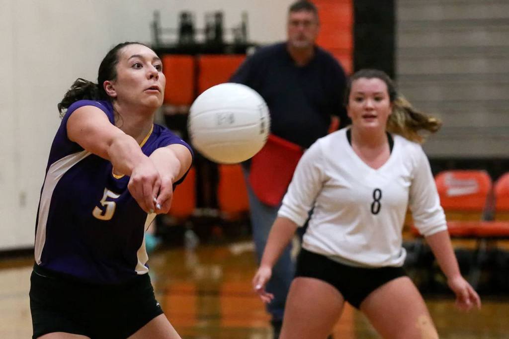 Lake Stevens&rsquo; Gabby Gunterman makes a dig as teammate Emily Lubick looks on during the Vikings&rsquo; five-set victory on Thursday night at Monroe. (Kevin Clark / The Herald)