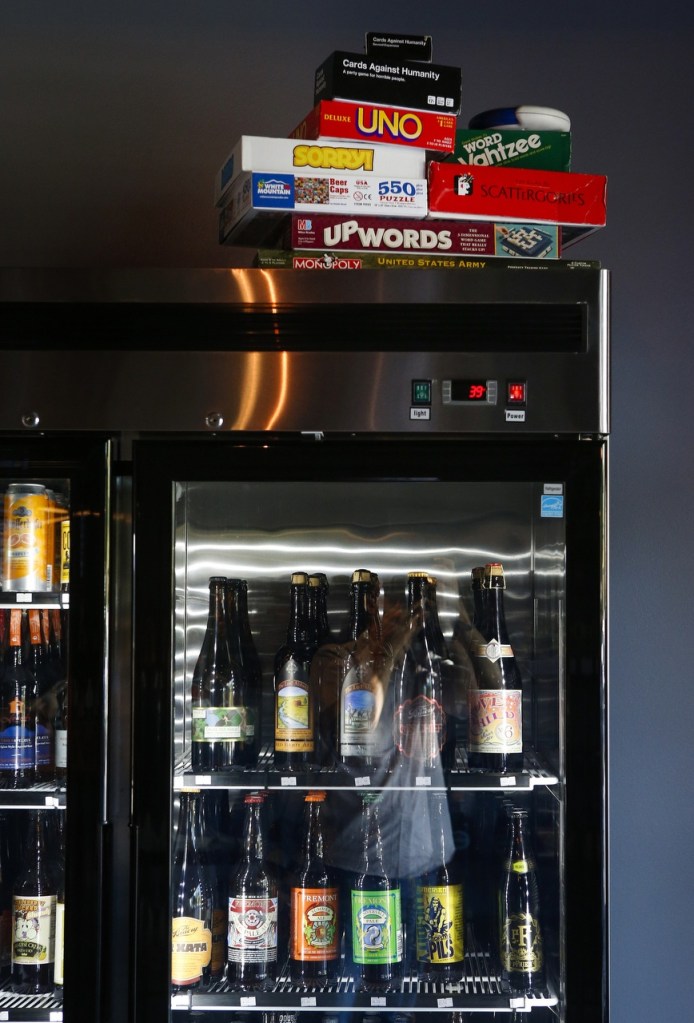 Board games sit on top of a cooler. (Ian Terry / The Herald)