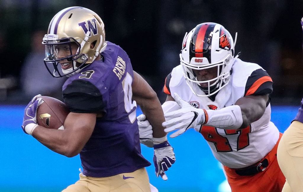 Washington&rsquo;s Myles Gaskin escapes a tackle attempt by Oregon State&rsquo;s Bright Ugwoegbu Saturday afternoon at Husky Stadium in Seattle. (Kevin Clark / The Herald)