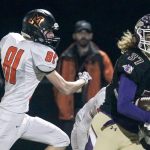 Lake Stevens&rsquo; Hunter Eckstrom runs for the end zone with Monroe&rsquo;s Skyler Barr trailing during a game Friday at Lake Stevens High School. (Kevin Clark / The Herald)