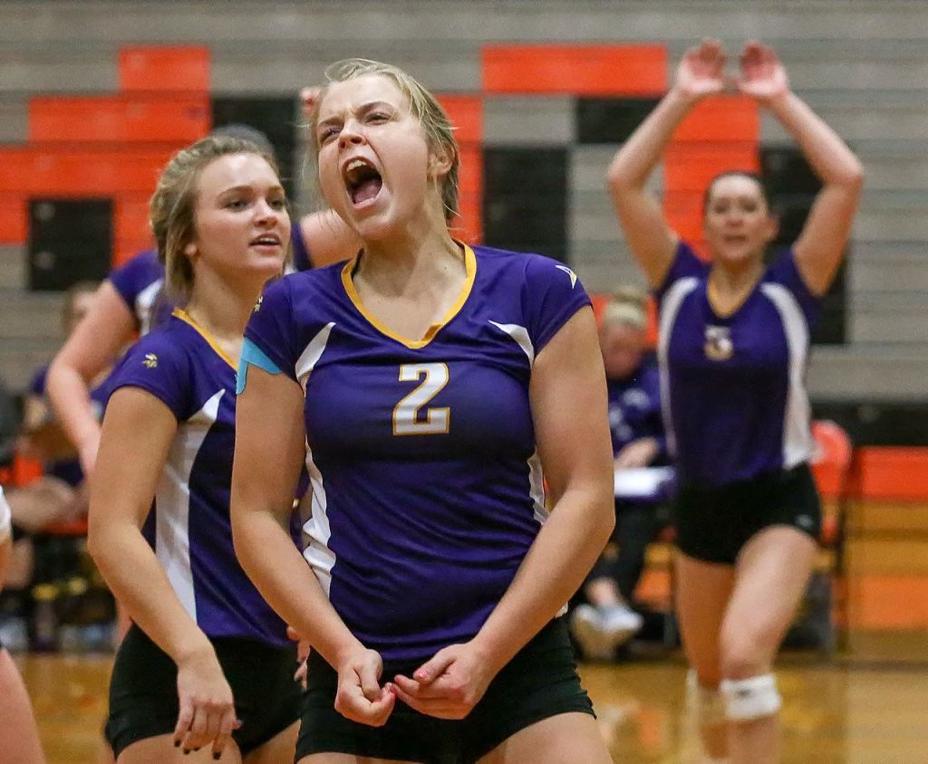 Lake Stevens&rsquo; Lilly Eason (center) celebrates as teammate Melissa Stevens (left) looks on during the Vikings&rsquo; five-set victory Thursday night at Monroe. (Kevin Clark / The Herald)