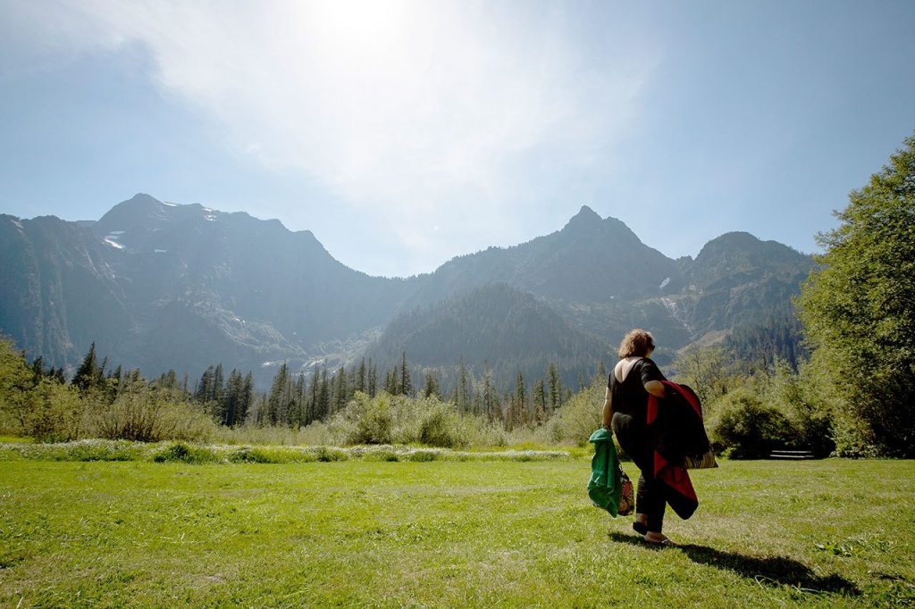 Rose Loven of Marysville takes a stroll in the grass at the Big Four Ice Caves Picnic Area off the Mountain Loop Highway. (Daniella Beccaria / For The Herald)