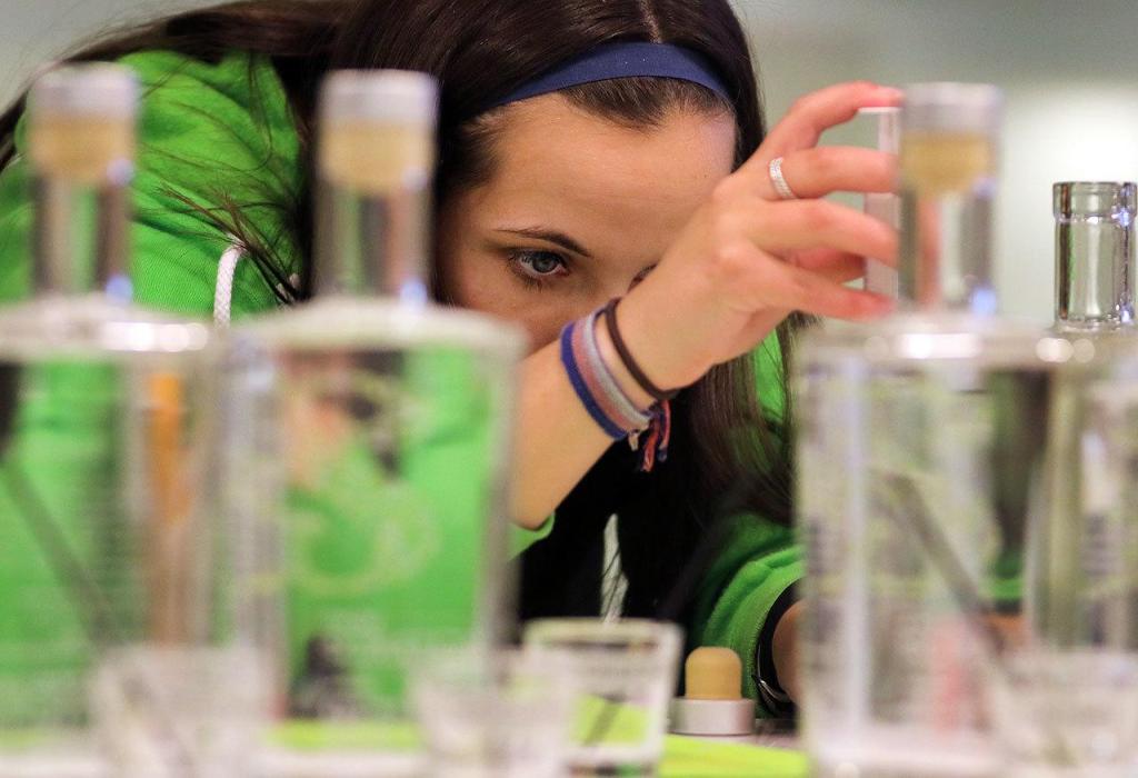 Corrissa Kellett mixes a custom Gin during the Giniology class at Scratch Distillery Saturday night in Edmonds on April 17, 2016. (Kevin Clark / The Herald)