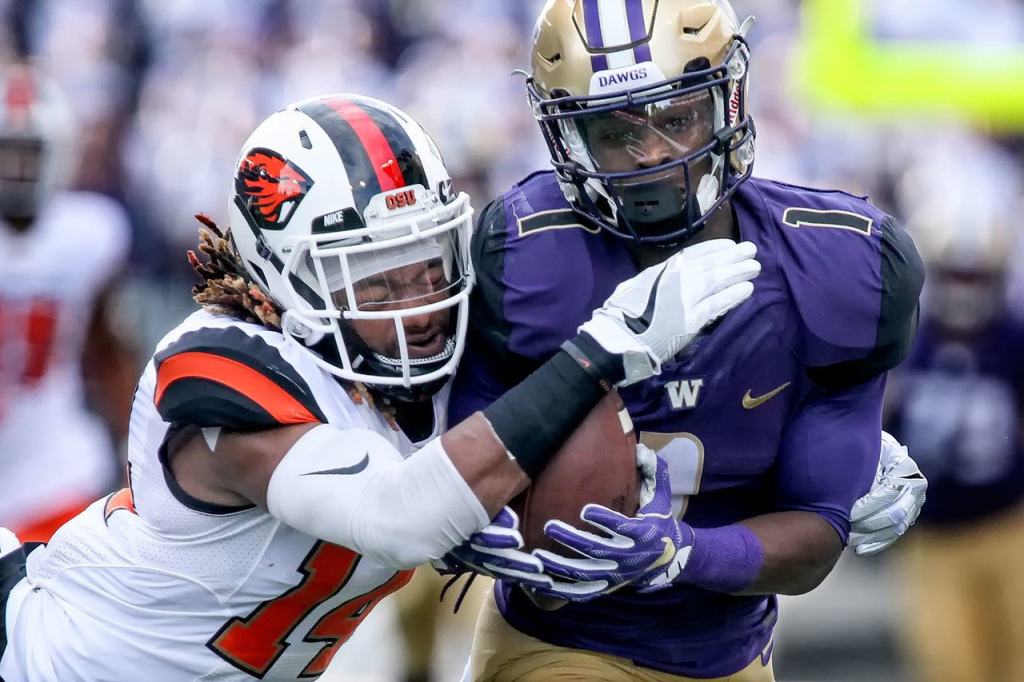 Washington&rsquo;s John Ross makes a catch with Oregon State&rsquo;s Treston Decoud attempting a tackle Saturday afternoon at Husky Stadium in Seattle on October 22, 2016. (Kevin Clark / The Herald