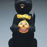 Black cats are symbols of Halloween and this cat even holds a jack-o&rsquo;-lantern. The rare vintage nodding cat sold for over $4,000 in 2016. (Cowles Syndicate Inc.)