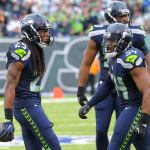 Seattle Seahawks cornerback Richard Sherman (left) celebrates with linebacker Bobby Wagner after Sherman intercepted a pass in the second half of Sunday&rsquo;s game in East Rutherford, N.J. (AP Photo/Bill Kostroun)