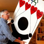At his home in Everett Thursday, Chris Hoiby moves a door-full of reasons to celebrate the 30th anniversary of the Snohomish County Children&rsquo;s Commission in preparation for next week&rsquo;s event, which will honor past and present volunteers. (Dan Bates / The Herald)