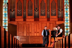 At Everett&rsquo;s First Presbyterian Church on Monday, church organist Gary Norris (right) talks with John Moir, of Balcom and Vaughan Pipe Organs. Moir designed the nearly two-story-high organ, which contains more than 2,000 pipes. (Dan Bates / The Herald)