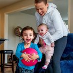 Carrying 4-month-old Haven, Apryl Roberts chases 2-year old Charlee around the house Wednesday, to the delight of all three. (Dan Bates / The Herald)