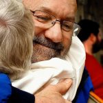 Frank Fargo, who offers free showers out of his trailer, is among 2016 KSER Voice of the Community Award winners. He is shown here in 2012 getting a hug from Lois Sugars at Everett&rsquo;s First Presbyterian Church, where he provides showers during a weekly dinner for people who are homeless. (Sarah Weiser / The Herald)