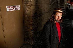 Musician Jason Webley looks around a gritty slice of old-Everett in the alley outside the Historic Everett Theatre, where he and other singer-songwriters will perform a concert Nov. 4 based on the Everett Massacre. The show, &ldquo;100 Years Ago Tomorrow,&rdquo; will feature original songs related to the labor strife that exploded in a gunfight on Everett&rsquo;s waterfront Nov. 5, 1916. (Dan Bates / The Herald)