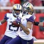 Washington punt returner Dante Pettis eludes Utah&rsquo;s Jackson Barton on his way to a touchdown in the second half of Saturday&rsquo;s game in Salt Lake City. (AP Photo/Rick Bowmer)