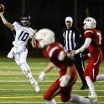 Arlington quarterback Anthony Whitis (10) delivers a pass downfield during a district play-in game against Snohomish on Tuesday at Snohomish High School. (Ian Terry / The Herald)