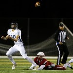 Arlington&rsquo;s Griffin Gardoski (left) watches a pass before catching it and turning for a touchdown as Snohomish&rsquo;s Josh Johnston slips on the play during the first quarter of a district play-in game Tuesday at Snohomish High School. (Ian Terry / The Herald)