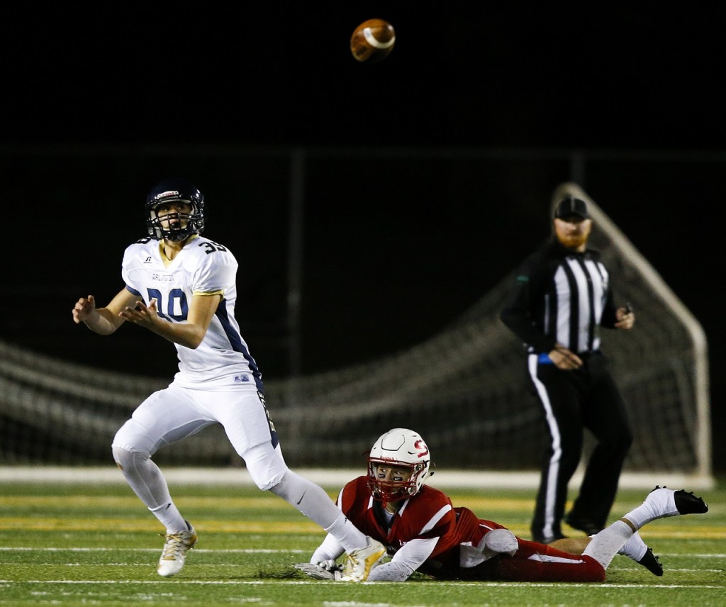 Arlington&rsquo;s Griffin Gardoski (left) watches a pass before catching it and turning for a touchdown as Snohomish&rsquo;s Josh Johnston slips on the play during the first quarter of a district play-in game Tuesday at Snohomish High School. (Ian Terry / The Herald)