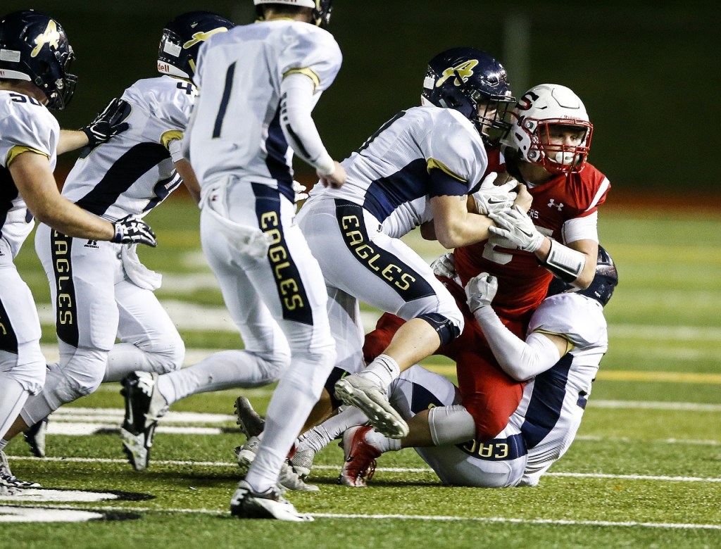 Snohomish&rsquo;s Keegan Stich (right) is brought down by a swarm of Arlington defenders during a district play-in game Tuesday at Snohomish High School. (Ian Terry / The Herald)