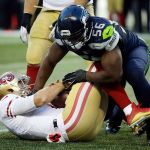 Seahawks defensive end Cliff Avril (right) sacks 49ers quarterback Blaine Gabbert during a game last season in Seattle. (AP Photo/Elaine Thompson)