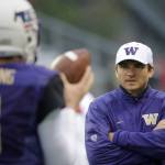 Washington offensive coordinator Jonathan Smith (right) looks on as quarterback Jake Browning goes through warm-ups before a game against Utah last season in Seattle. The oft-criticized Smith has the Huskies&rsquo; offense firing on all cylinders so far this season. (AP Photo/Ted S. Warren)