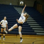 Arlington&rsquo;s Madison Burkett (center) hits a ball across the court during a team practice at the school on Wednesday. (Ian Terry / The Herald)