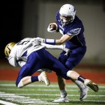 Meadowdale&rsquo;s Will Schafer (right) brushes off a tackle attempt by Kelso&rsquo;s Emmitt Kinch during the first half of a first round 3A state playoff game Friday at Edmonds Stadium. (Ian Terry / The Herald)
