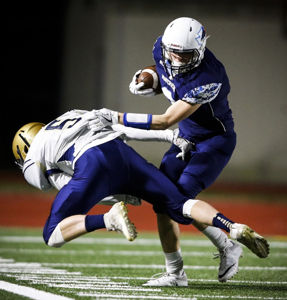 Meadowdale&rsquo;s Will Schafer (right) brushes off a tackle attempt by Kelso&rsquo;s Emmitt Kinch during the first half of a first round 3A state playoff game Friday at Edmonds Stadium. (Ian Terry / The Herald)