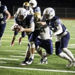 Meadowdale quarterback Drew Tingstad (left) lunges for the end zone for a touchdown during the first half of a first round 3A state playoff game Friday at Edmonds Stadium. (Ian Terry / The Herald)