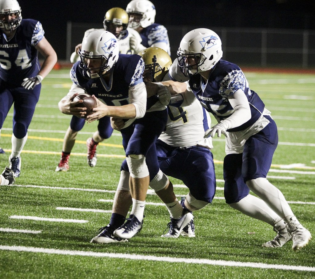 Meadowdale quarterback Drew Tingstad (left) lunges for the end zone for a touchdown during the first half of a first round 3A state playoff game Friday at Edmonds Stadium. (Ian Terry / The Herald)