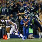 Seahawks tight end Jimmy Graham (88) leaps over Bills cornerback Stephon Gilmore (second from left) in the first half of a game this past Monday in Seattle. (AP Photo/Elaine Thompson)
