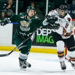 Silvertips left wing Matt Fonteyne (left) bats the puck away from Calgary&rsquo;s Jackson van de Leest during Everett&rsquo;s 6-1 win over Calgary on Tuesday at Xfinity Arena in Everett. (Ian Terry / The Herald)