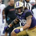 Washington linebacker Psalm Wooching celebrates after sacking Stanford quarterback Ryan Burns (not shown) during a game Sept. 30 in Seattle. (AP Photo/Ted S. Warren)
