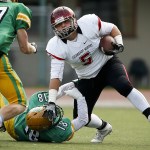 Archbishop Murphy&rsquo;s Ben Hines (right) stiff-arms Tumwater&rsquo;s Andrew May to the ground during a 2A state playoff game at Tumwater High School on Saturday. (Ian Terry / The Herald)