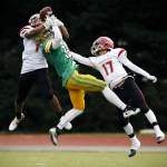 Archbishop Murphy&rsquo;s Anfernee Gurley (left) bats away a pass intended for Tumwater&rsquo;s Andrew May (center) as Archbishop Murphy&rsquo;s Dillon Singh Halpin (right) defends during a 2A state playoff game at Tumwater High School on Saturday. (Ian Terry / The Herald)