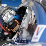 Jimmie Johnson gets in his car as he prepares for NASCAR Sprint Cup practice on Saturday in Homestead, Fla. On the back of Johnson&rsquo;s helmet are Dale Earnhardt (left) and Richard Petty (right) are pictured, as both have seven series championships. Johnson has six and could win his seventh on Sunday. (AP Photo/Terry Renna)