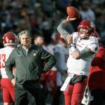 Washington State&rsquo;s Luke Falk (right) warms up as coach Mike Leach looks on in the first half of the Cougars&rsquo; game against Colorado last Saturday in Boulder, Colo. Falk leads the Cougars against Washington in the Apple Cup on Friday. (AP Photo/David Zalubowski)