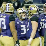 Washington quarterback Jake Browning (3) huddles with teammates on the sideline during a game against Arizona State on Nov. 19 in Seattle. Browning will lead the Huskies against Washington State in Friday&rsquo;s Apple Cup. (AP Photo/Ted S. Warren)