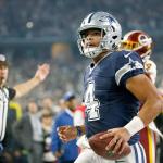 An official signals touchdown as Dallas quarterback Dak Prescott (4) runs the ball into the end zone during the second half of the Cowboys&rsquo; win over Washington on Thursday in Arlington, Texas. (AP Photo/Ron Jenkins)