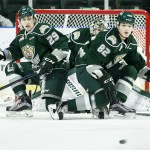 Everett&rsquo;s Wyatte Wylie (29) and Eetu Tuulola (82) kneel down to block a shot together as goalie Carter Hart peeks through during a game against Kootenay on Wednesday at Xfinity Arena in Everett. (Ian Terry / The Herald)