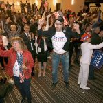 At a Republican election-night party early Wednesday in Greenwood Village, Colorado, Jake Viano jumps as President-elect Donald Trump gives his acceptance speech. (AP Photo/Jack Dempsey)