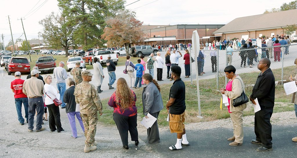 People stand in a long line to vote at the Smiths Station Jr High polling place in Smiths Station, Alabama, on Tuesday. (Todd J. Van Emst/Opelika-Auburn News via AP)