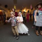 Watching an instructor, Addie Townsend, 7, bumps into her brother James, 4, as they learn to line dance at Stilly Brook Farm on Nov. 3 in Arlington. Senior and Cadette Girl Scouts of Troop 42168 hosted a barn dance for school-age kids to raise money for four senior girls to go to Europe. (Andy Bronson / The Herald)