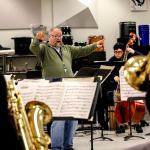 Edmonds Community College jazz band director John Sanders leads a rehearsal Monday of jazz and salsa band students at Edmonds Community College, which is trying to raise money to attend the Fiesta del Tambor in Havana this March. (Dan Bates / The Herald)