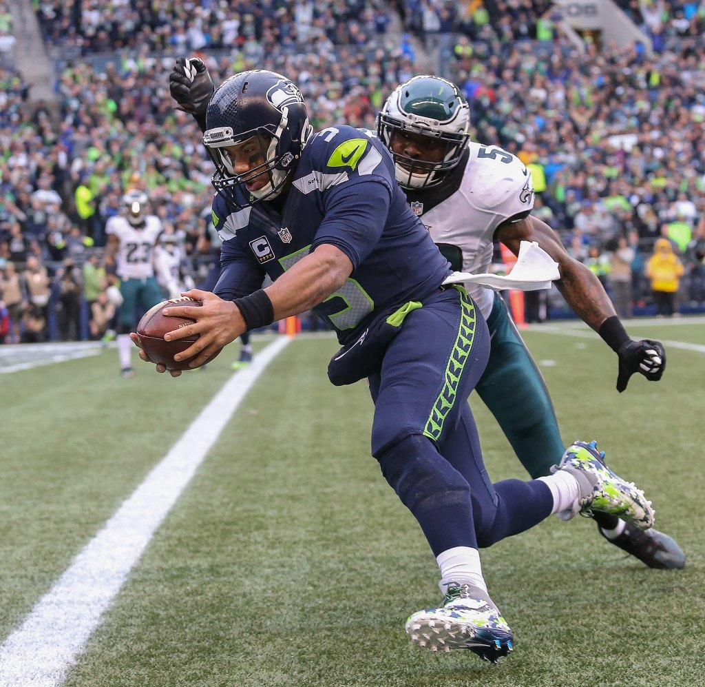 Seattle Seahawks quarterback Russel Wilson dives in for the touchdown as Philadelphia Eagles&rsquo; Nigel Bradham tries to hit the ball from his hands during the third quarter at CenturyLink Field on Sunday, Nov. 20, 2016 in Seattle, Wa. (Andy Bronson / The Herald)
