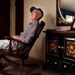 Raymond Lund, 95, a World War II veteran who served in Europe, including landing on the beach at Normandy on D-Day, sits in a rocker at his home in Stanwood. A framed photograph of his wife, Aileen sits on a cabinet behind him with a lei hanging over it. Aileen, who died last year, and Ray were married for 65 years. (Dan Bates / The Herald)