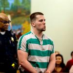 Jacob Tusken is led into Snohomish County Superior Court on Monday to be sentenced for the first-degree assault of his infant daughter. The child was left with permanent brain injuries and will require constant care for life. (Dan Bates / The Herald)