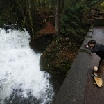 From his longboard, Tucker Fellows snaps a photo of Whatcom Falls in Bellingham on Friday, Nov. 11. (Ian Terry / The Herald)
