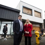 Attorneys Brian and Melissa Sullivan stand in front of their former office (at left) on Rockefeller Avenue in Everett on Nov. 2. After the county took hold of the block through eminent domain two years ago, the Sullivans were forced to move. Since then, the buildings have sat vacant with no signs of development. (Ian Terry / The Herald)