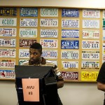Delvin Ebbesen (left), of Everett, uses an accessible voting unit to cast his ballot at the Snohomish County campus building in Everett on Tuesday. (Ian Terry / The Herald)