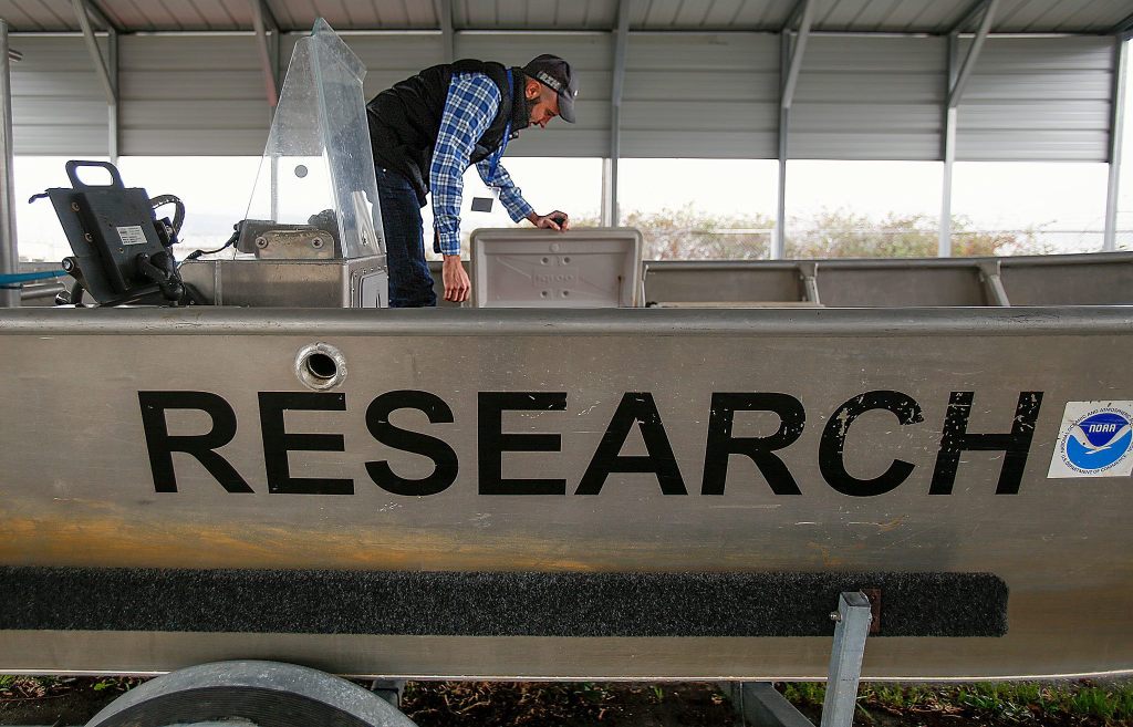 Barney Boyer checks a container in the &ldquo;R/V Seahawk,&rdquo; a National Oceanic and Atmospheric Administration research boat. An Air Force veteran who served in Qatar at the Al Udeid Air Base during the early years of the Iraq war, Boyer, 35, is the first military veteran with a NOAA Fisheries internship. He is based at the Northwest Fisheries Science Center&rsquo;s Mukilteo Research Station. (Dan Bates / The Herald)
