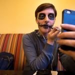 Amanda Brown, 17, from Lakewood High School, applies makeup, using her cellphone as a mirror, as other students and faculty compete in the Hallo-Scream Contest at Everett Community College on Monday. (Andy Bronson / The Herald)